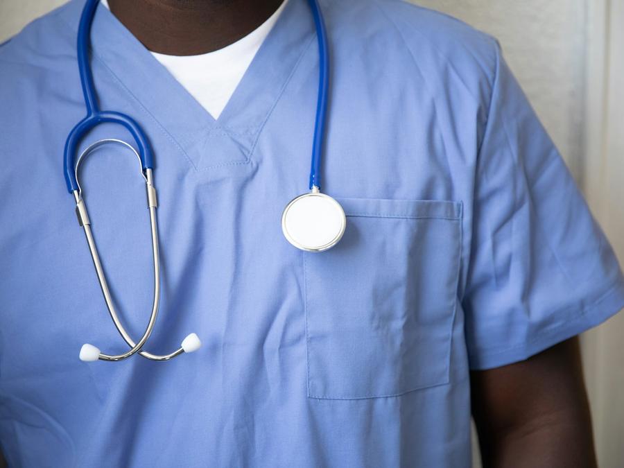 A doctor in scrubs with a stethoscope