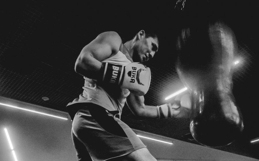 A boxer shadow boxing in a gym